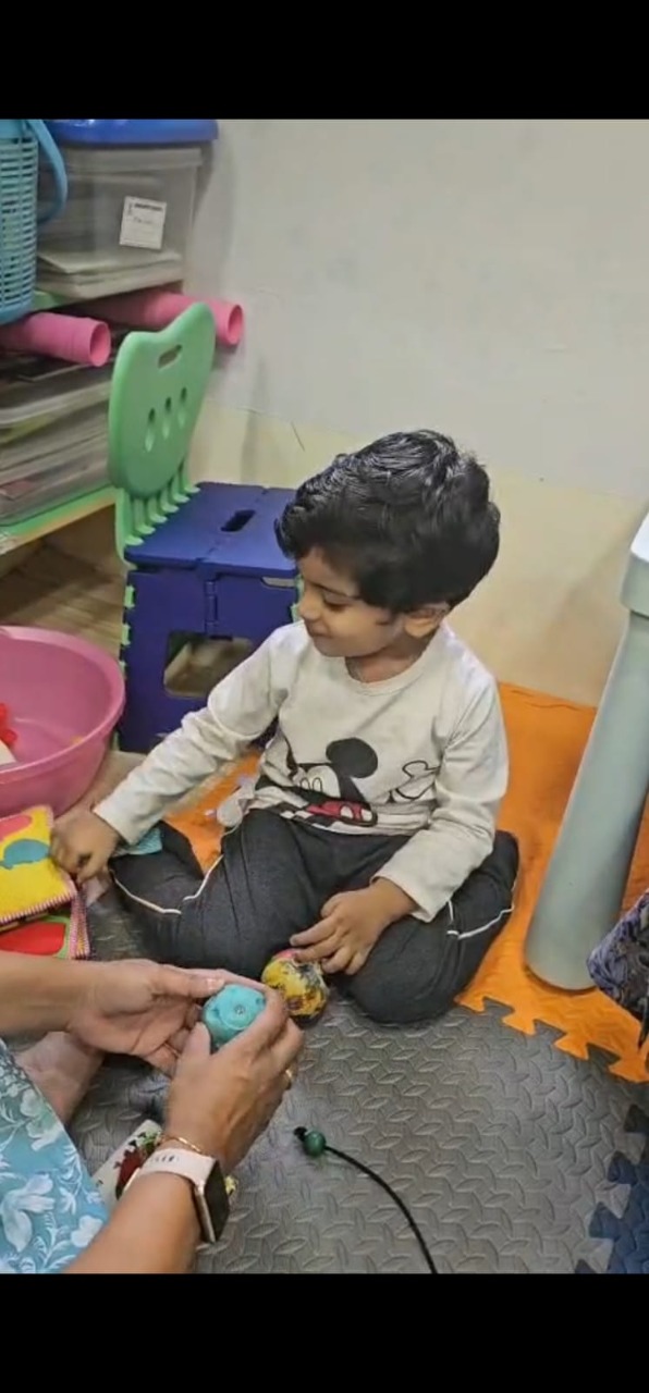 Young child engaged in a sensory play activity at Mansa Clinic